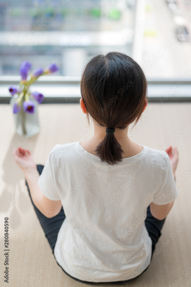 A young woman has indoor mediation in cities. A young woman has indoor mediation in cities.