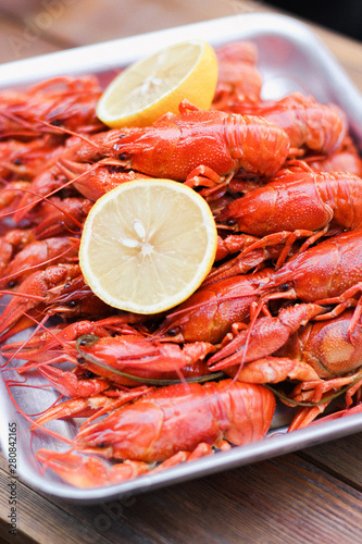A lot of  bright red boiled  crawfish with lemon