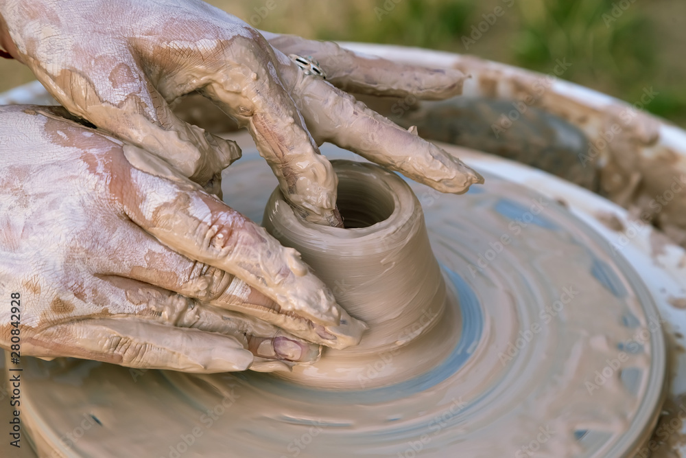Creating a sculpture of clay close-up. Hands making products from clay. The sculptor at work.
