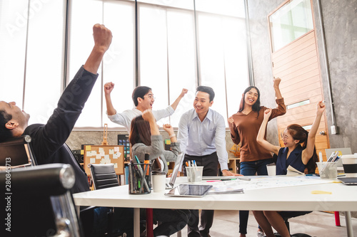 Business people smile and raise hands up, feeling happy, complete finish job, teamwork successful/achievement working in office concept photo