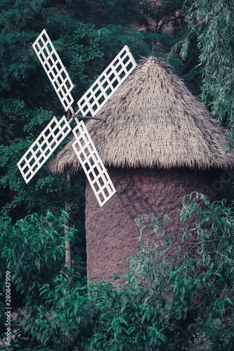 Outdoor turning barn windmill and green woods photo