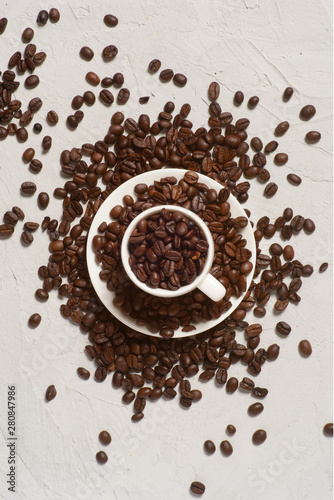 Coffee background, top view with copy space. White cup of coffee, ground coffee, coffee beans on white background