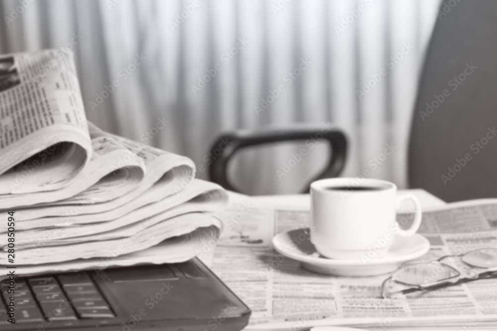 Newspaper on the desk, laptop, cup of coffee. Newspaper on the desk, laptop, cup of coffee.