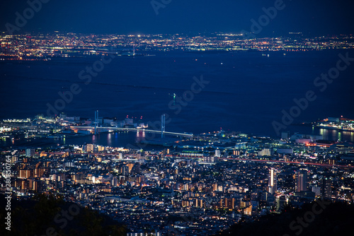 Night view of Kobe and Osaka Bay which see from viewpoint on Rokko mountain in Kobe, Japan. Travel in Japan concept. Night view of bay, bridge and building