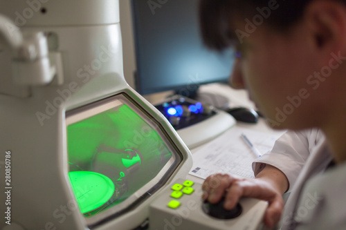 Analyst controlling an Analytical Transmission Electron Microscope, asbestos (ATEM) to detect asbestos fibers in construction materials photo