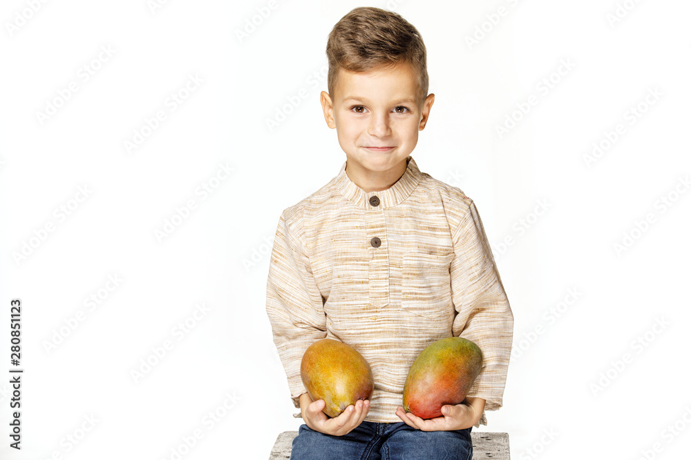 Fototapeta premium handsome pretty boy is holding a mango