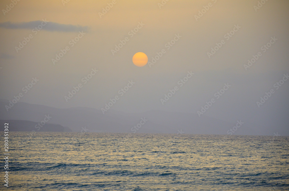 Tranquil Sunrise over the Ocean in Fuerteventura, Canary Islands Tranquil Sunrise over the Ocean in Fuerteventura, Canary Islands