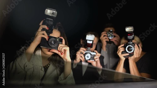 Celebrity looking from car at newspaper paparazzi making shoots, point of view