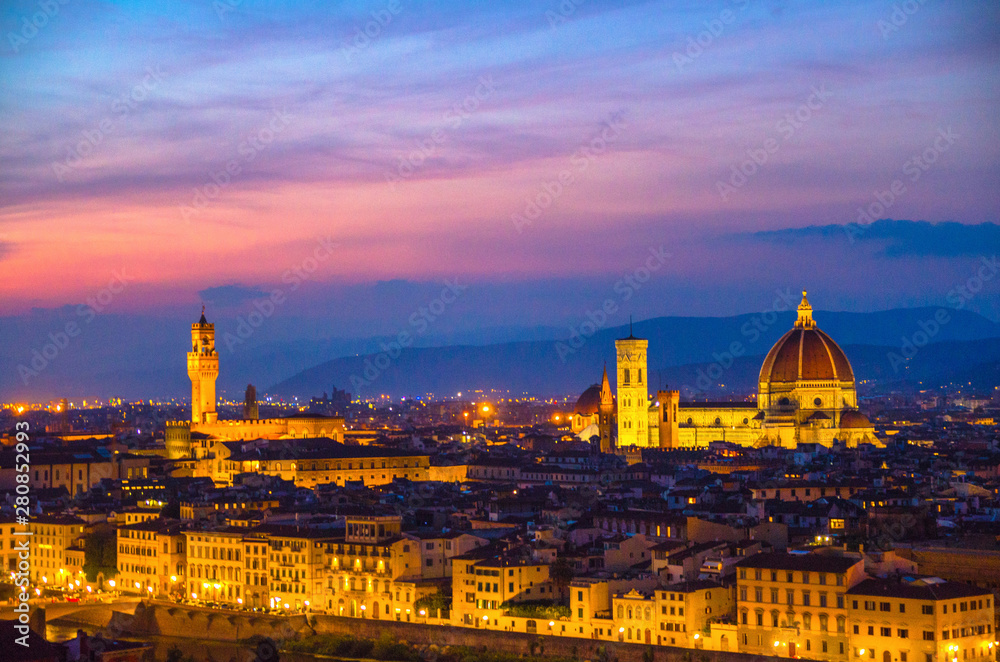 Top aerial panoramic evening view of Florence city with Duomo Cattedrale di Santa Maria del Fiore cathedral and Palazzo Vecchio palace at night dusk twilight, city lights, blue sky, Tuscany, Italy