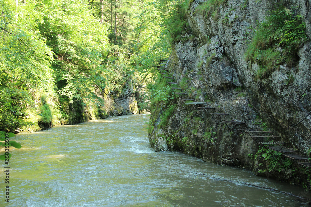 Dangerous trail through a waterfall with steel ladders in the Slovak Paradise National Park, Slovaki Dangerous trail through a waterfall with steel ladders in the Slovak Paradise National Park, Slovaki