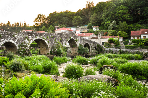 Summer in northern part of Spain. Roman stone bridge in Ponte Maceira (Negreira) town, Galicia, Spain