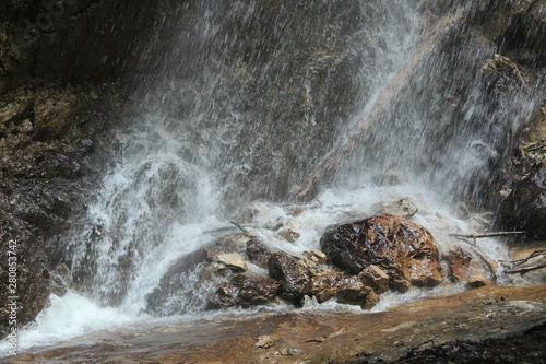 Splashing water on rocks from a falling waterfall