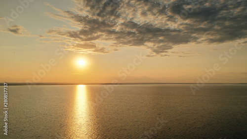 Beautiful view of the sea and sunset. Aerial view from flying drone of a beautiful nature landscape with dramatic clouds sunset sky and views of the sea surface. Postcard view. Nature