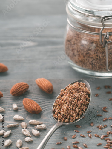 Homemade LSA mix in spoon - Linseed or flax seeds, Sunflower seeds and Almonds. Traditional Australian blend of ground, source of dietary fiber, protein, omega fatty acids. Copy space for text. photo