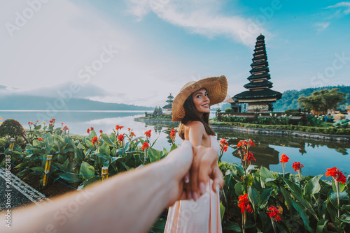 Couple spending time at the ulun datu bratan temple in Bali. Concept about exotic lifestyle wanderlust traveling photo