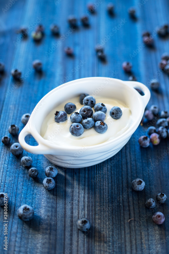 fresh tasty blueberry with natural yoghurt on wooden background fresh tasty blueberry with natural yoghurt on wooden background