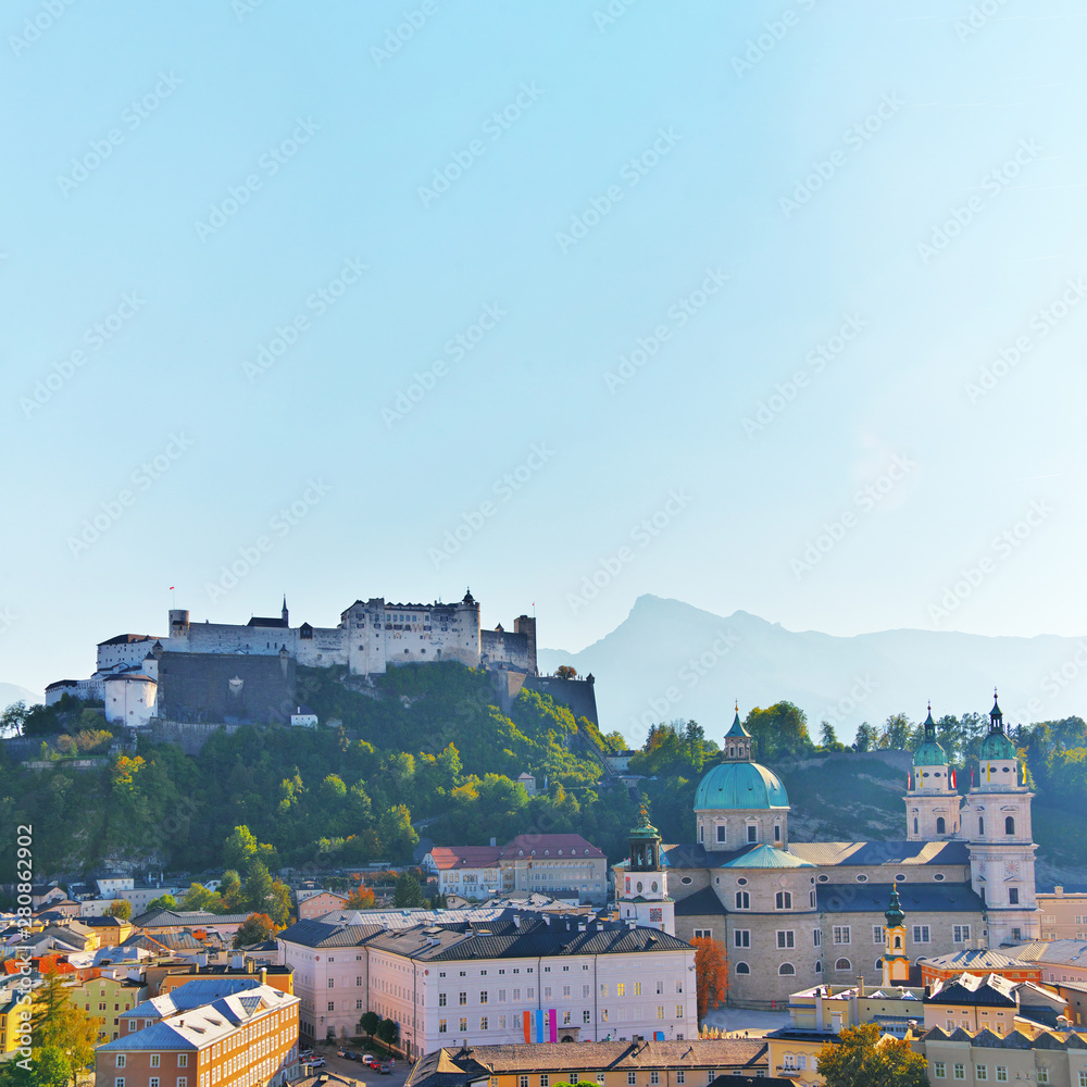 Aerial view of the historic city of Salzburg with Festung Hohensalzburg Fortress and Salzburger Cathedral Dom. Old town scenery autumn sights. Salzburger Land, Austria. Unesco heritage at summer.