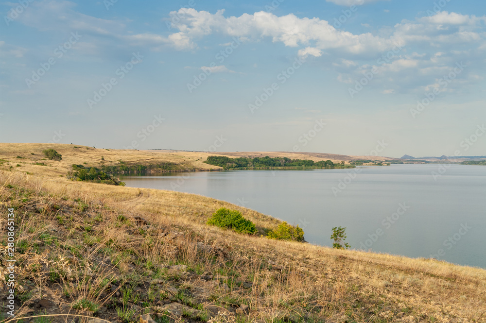 Eastern European steppe landscape with reservoir. End of summer. Landscape park, Donbass.