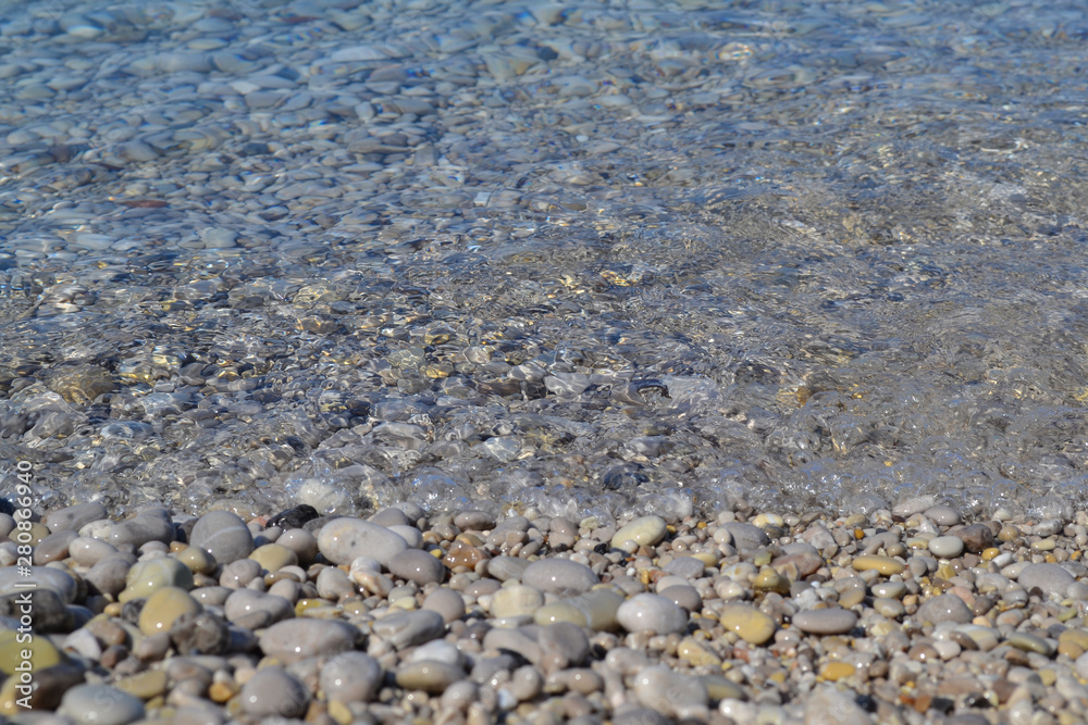 Sea stones in the sea water. Pebbles under water. The view from the top. Nautical background. Clean sea water. Transparent sea. Sea stones in the sea water. Pebbles under water. The view from the top. Nautical background. Clean sea water. Transparent sea.