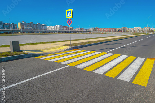 Open space with road signs and road markings, road intersections, pedestrian crossings, sunny day, blue sky, city landscape background