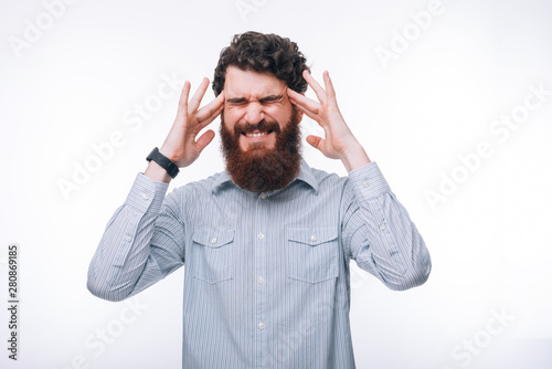 Photo of sad man in casual having headache at work