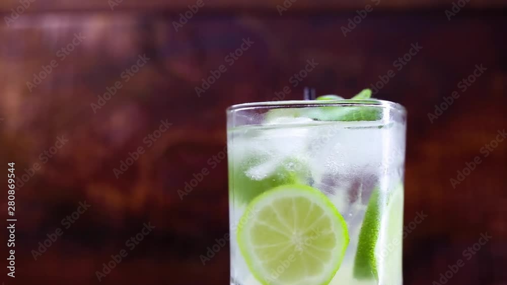 Typical drink from Brazil called Caipirinha, made with lemon and sugar with cachaça. Favorite cocktail of Brazil, isolated over wood texture. Typical drink from Brazil called Caipirinha, made with lemon and sugar with cachaça. Favorite cocktail of Brazil, isolated over wood texture.