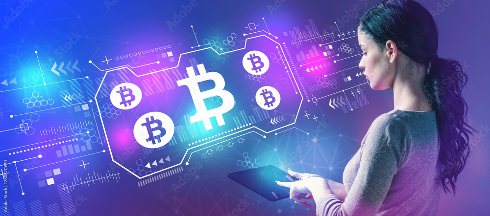 Bitcoin with business woman using a tablet computer Bitcoin with business woman using a tablet computer