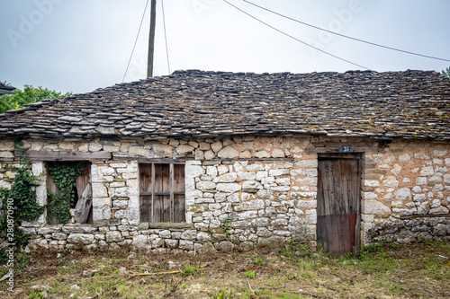 Abandoner ruined house, street view, Ioannina island on lake Pamvotida near the beautiful small island near the Greek town of Ioannina. Early morning dark spring day scene photo