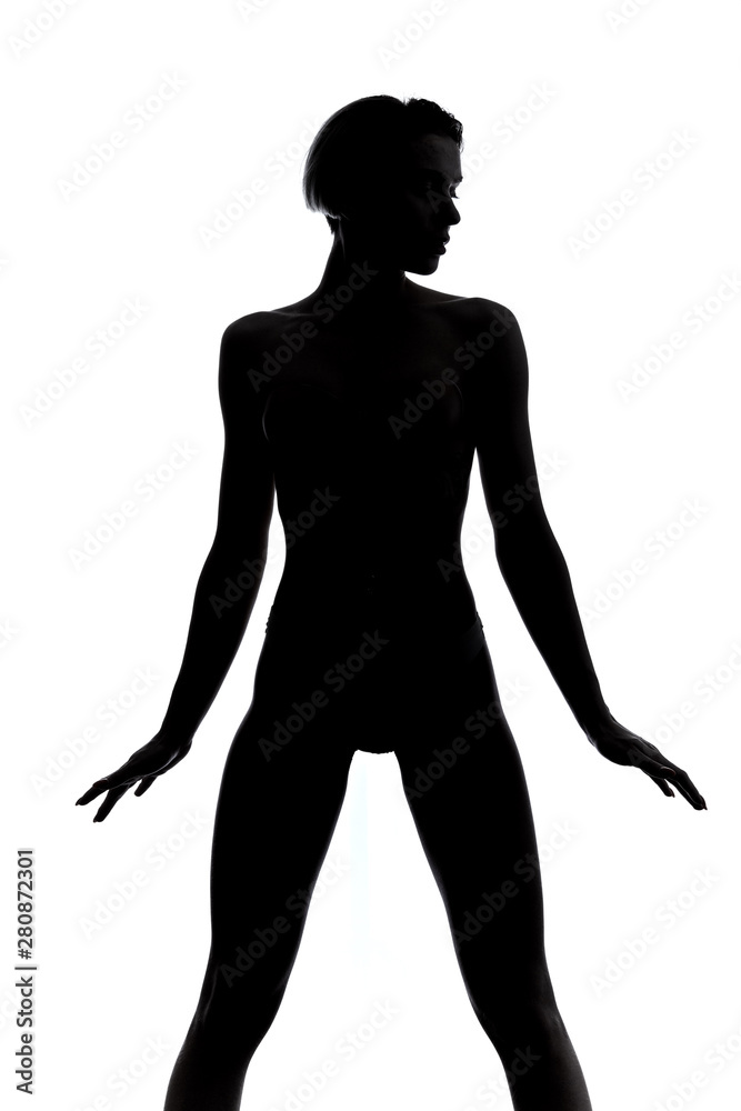 slim girl standing wide-legged over white background. close up portrait.