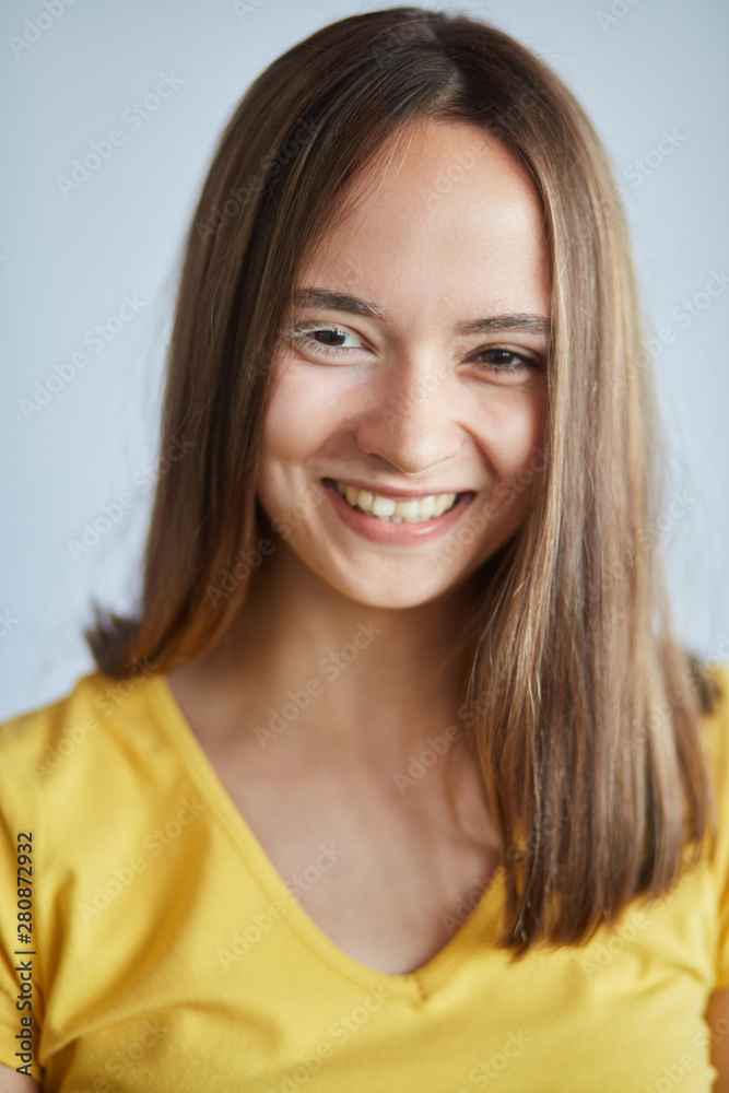 smiling cheerful girl in yellow T-shirt, expresses positive emotion, close up photo. happiness smiling cheerful girl in yellow T-shirt, expresses positive emotion, close up photo. happiness