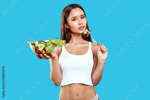 vegetarian thin good looking girl having breakfast after training at gym. close up photo. © alfa27
