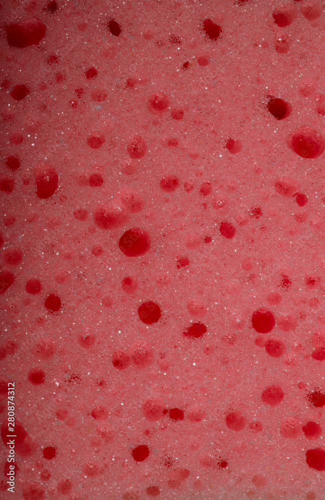 Abstract pink sponge texture background. Cropped shot, close-up, top view, vertical, no people, free space. Design concept.