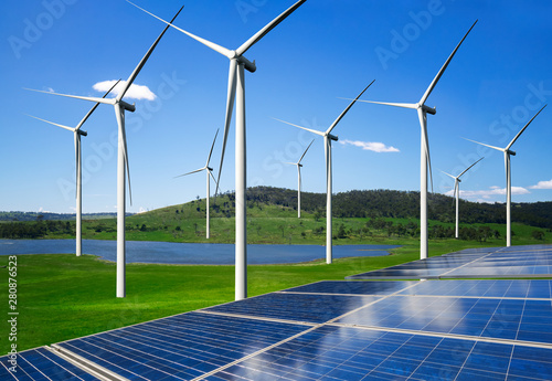 Solar energy panel photovoltaic cell and wind turbine farm power generator in nature landscape for production of renewable green energy is friendly industry. Clean sustainable development concept.