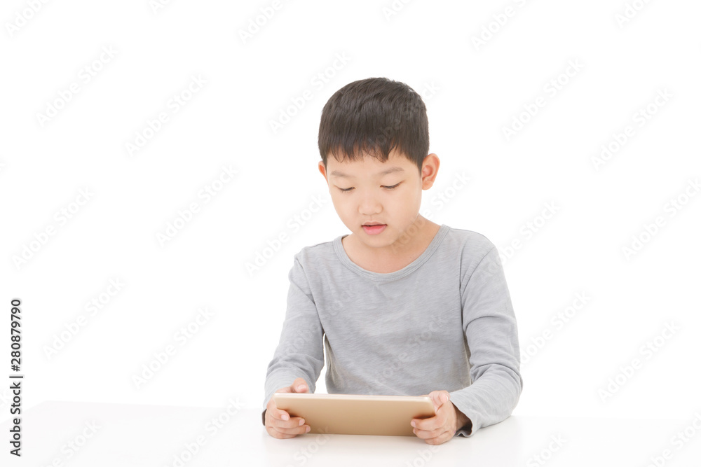 Asian boy using tablet computer isolated on white background. Asian boy using tablet computer isolated on white background.