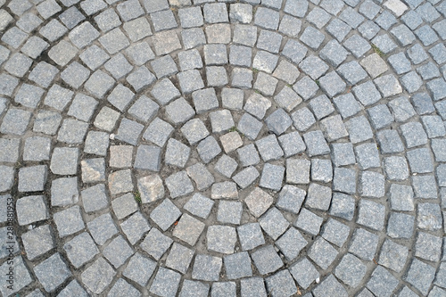 Texture of old Cobbled Pavement close-up. Abstract Granite Stone Background.