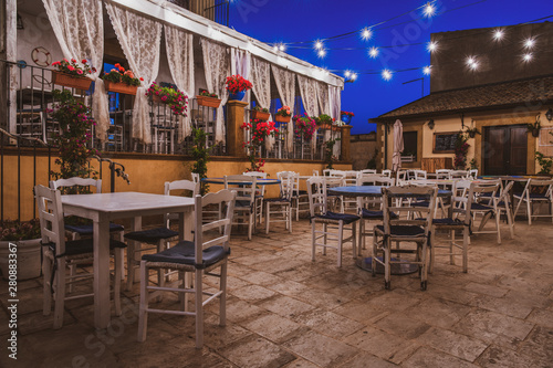 Fototapeta Naklejka Na Ścianę i Meble -  Typical italian cafe at night on the street of the beautiful coastal sicilian village Marzamemi in Sicily island, southern Italy