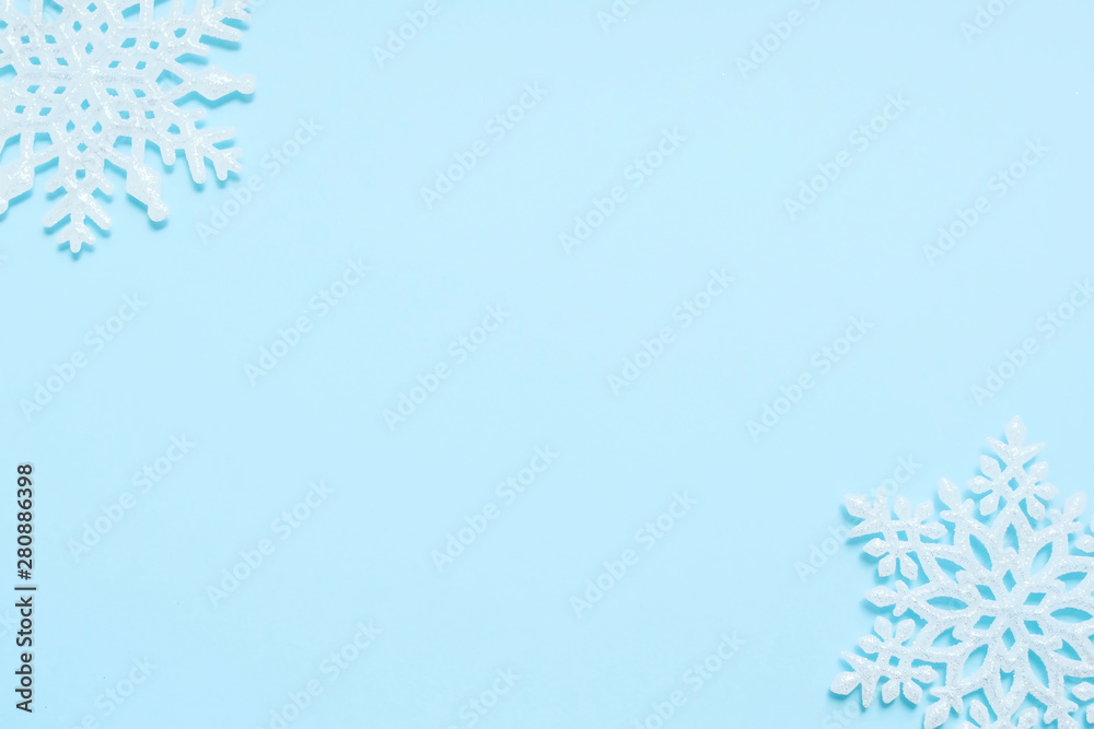 Christmas and new year concept. White snowflakes on blue background. Top view, flat lay composition, frame, layout. Copy space for text or design. Christmas and new year concept. White snowflakes on blue background. Top view, flat lay composition, frame, layout. Copy space for text or design.