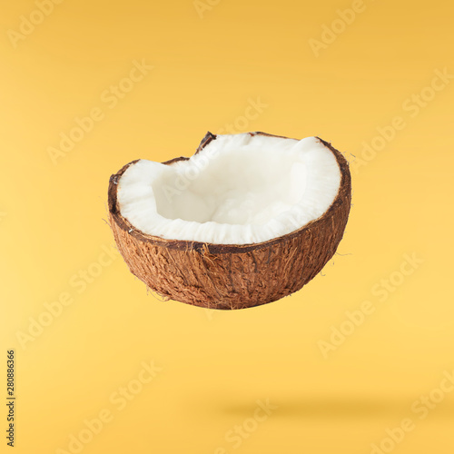 Fresh ripe coconut isolated on yellow background