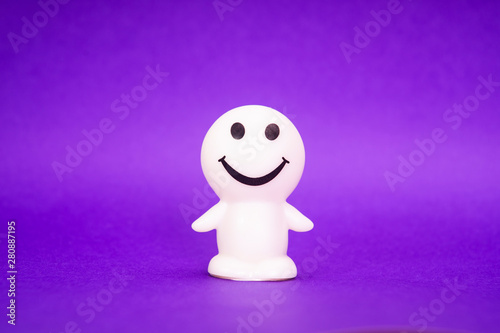 smiley face trinket on purple background