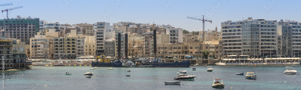 View of St julian's bay as seen from across the water at the Independence Gardens in Sliema in Malta