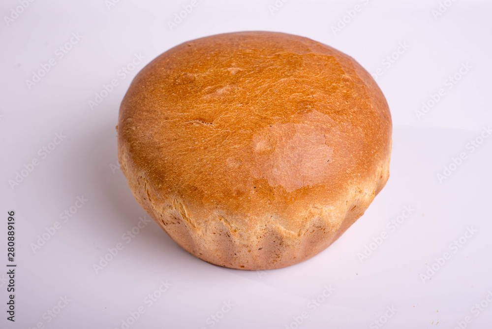 Beautiful white bread on a white background. Round baking