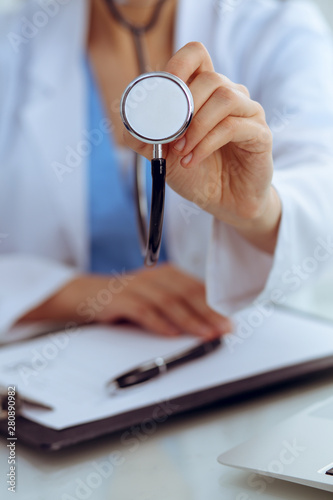 Doctor with a stethoscope in the hands, close up. Physician ready to examine and help patient. Medicine, healthcare and help concept