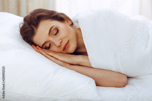 Beautiful young woman sleeping while lying in her bed. Concept of pleasant and rest reinstatement for active life