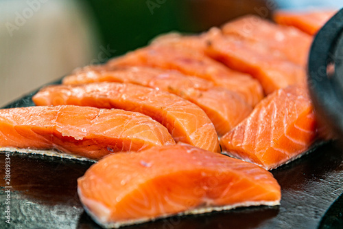 Closeup of a fresh fillet of salmon on hot grill.