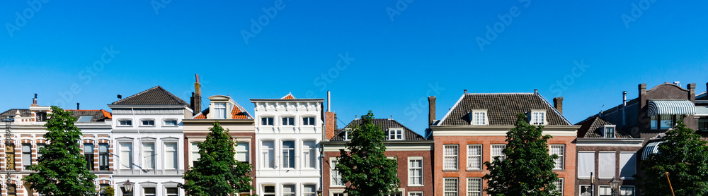 Panorama view. Facade of historical houses in street Wolwevershaven. Dordrecht, The Netherlands
