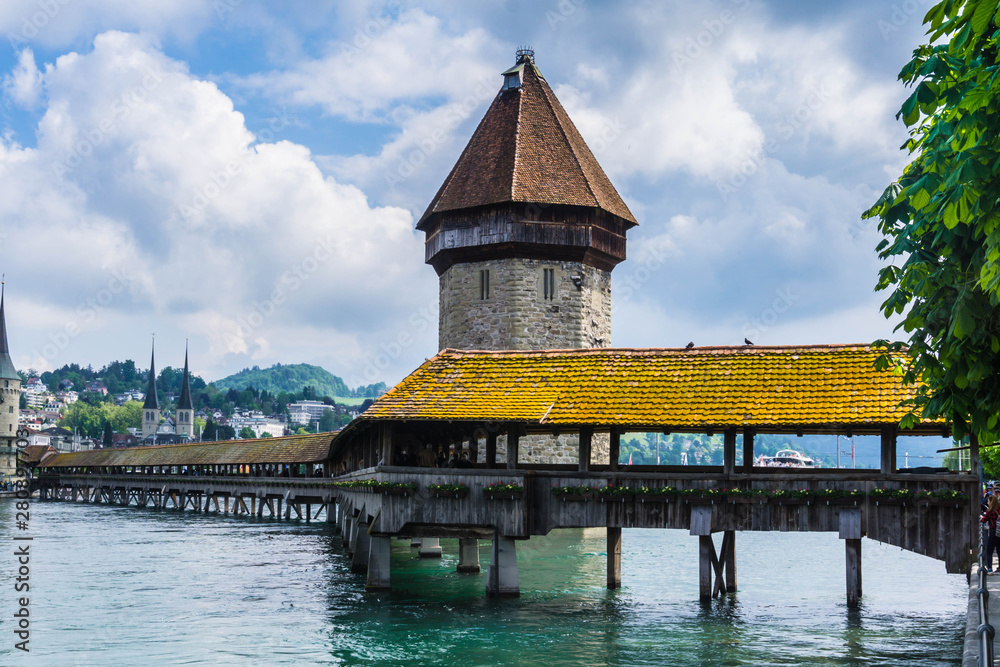 The Kapellbrücke (chapel bridge) a famous wooden covered bridge that spans the river reuss in the centre of the swiss city of lucerne