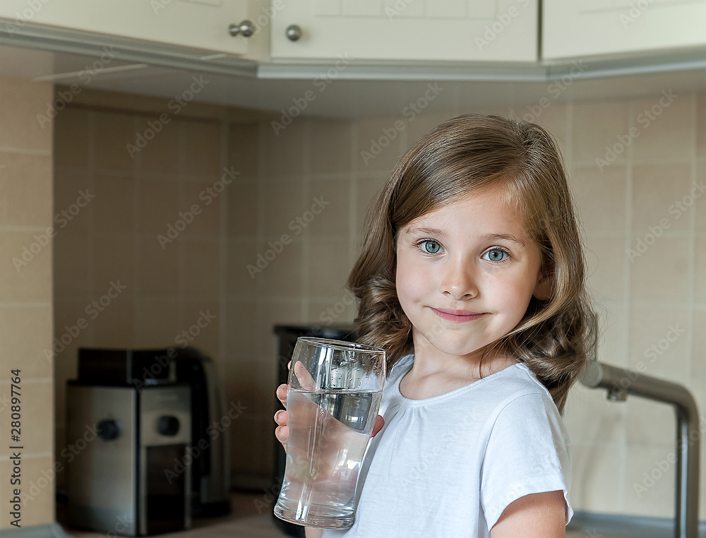 Little child is drinking clean water at home, close up. Caucasian cute girl with long hair is holding a water glass in her hands. Taking care of own health. Concept of healthy lifestyle, good habit Little child is drinking clean water at home, close up. Caucasian cute girl with long hair is holding a water glass in her hands. Taking care of own health. Concept of healthy lifestyle, good habit