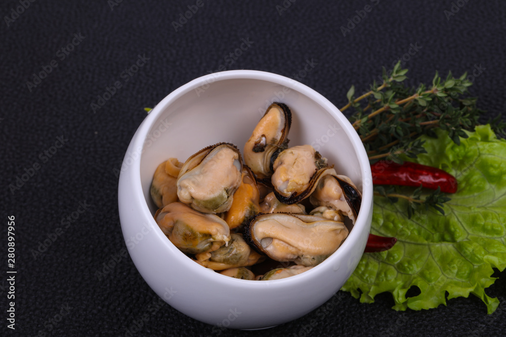 Pickled mussels in the bowl served pepper, garlic and salad Pickled mussels in the bowl served pepper, garlic and salad