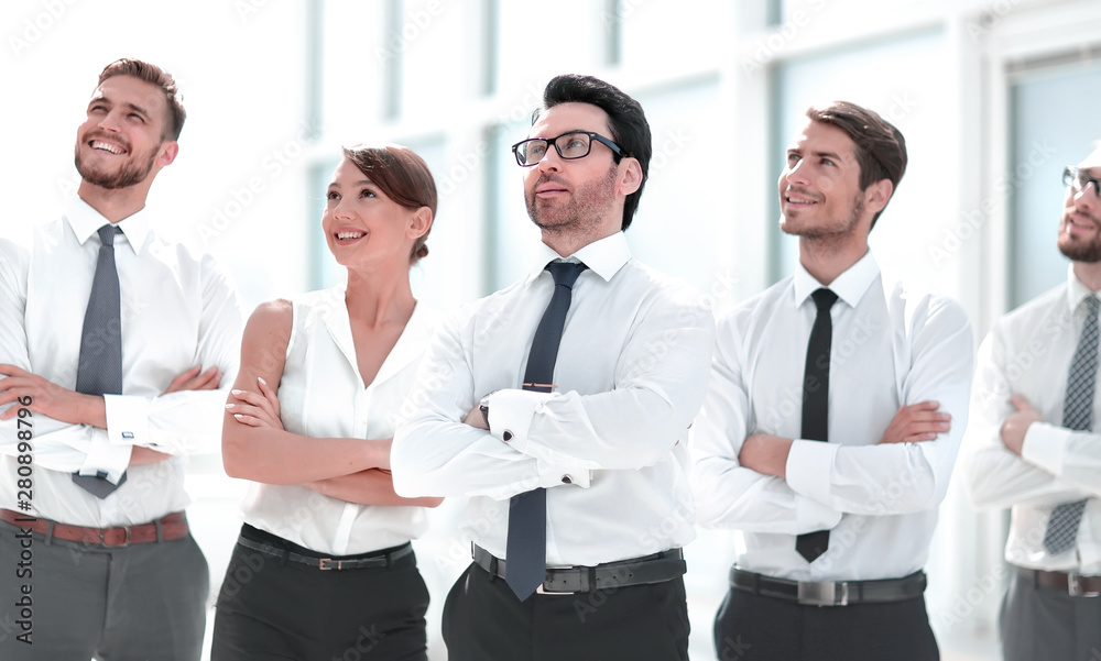 business team standing together and looking at copy space.
