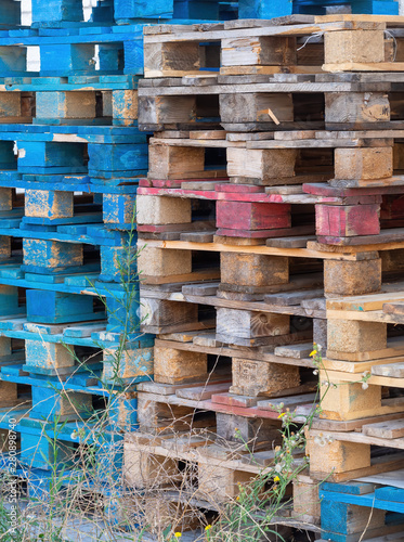 Old wooden pallets from cargo  shipping. Discarded  stacked.